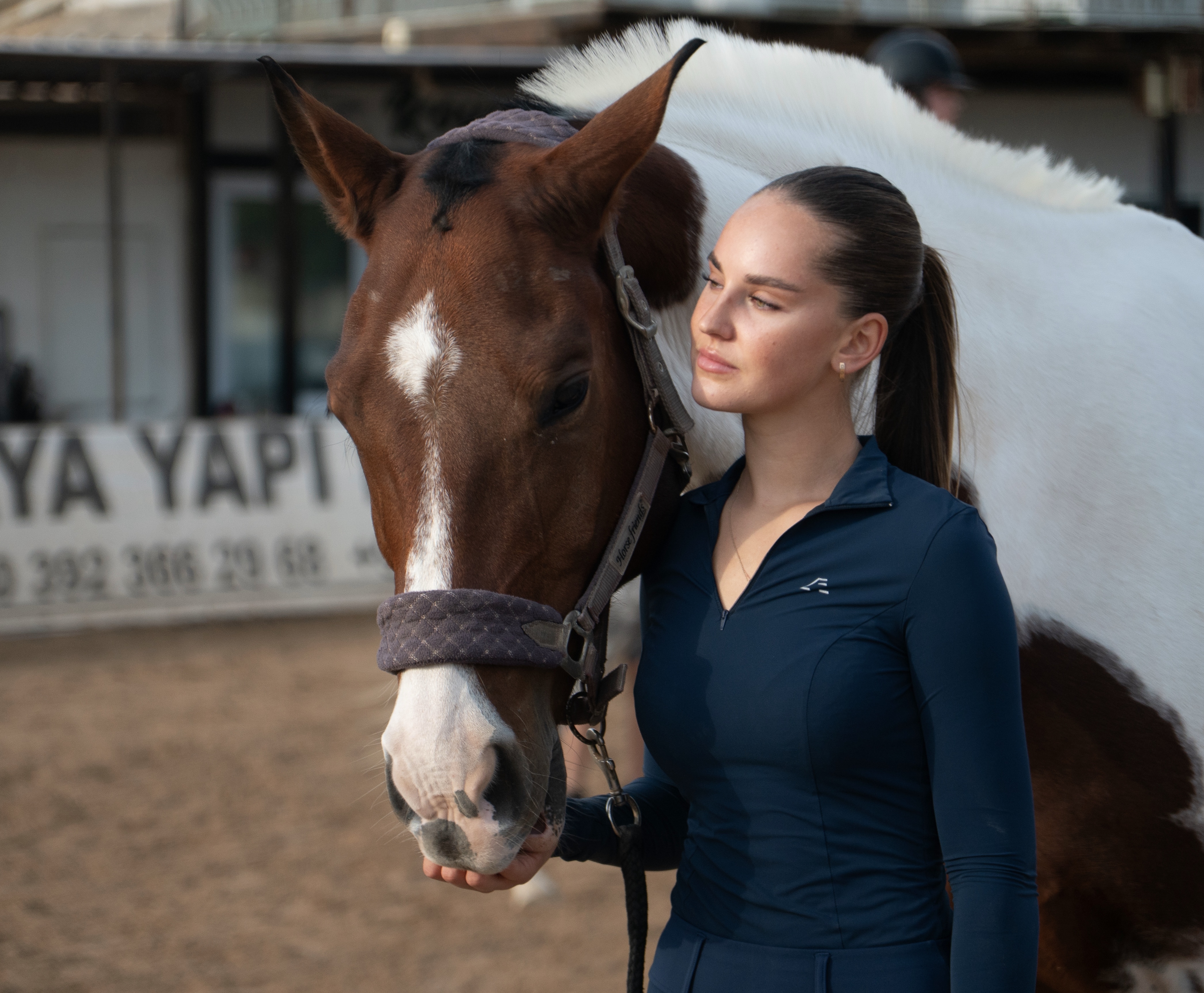Anna standing beside a horse