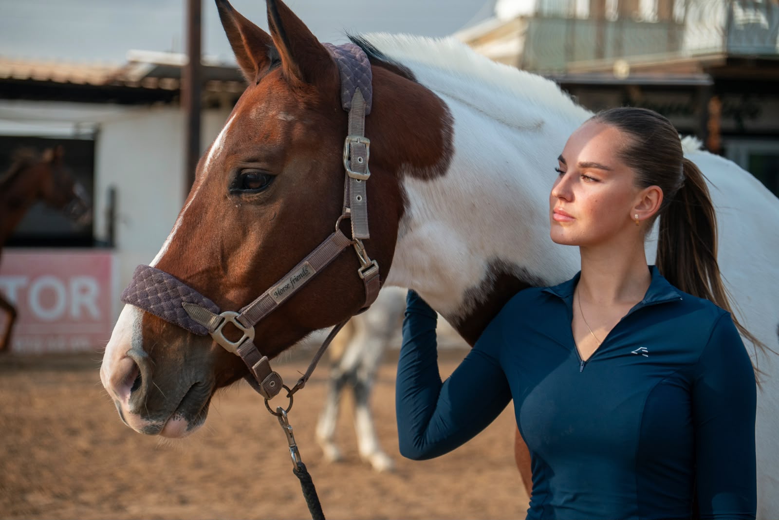 Anna standing beside a horse